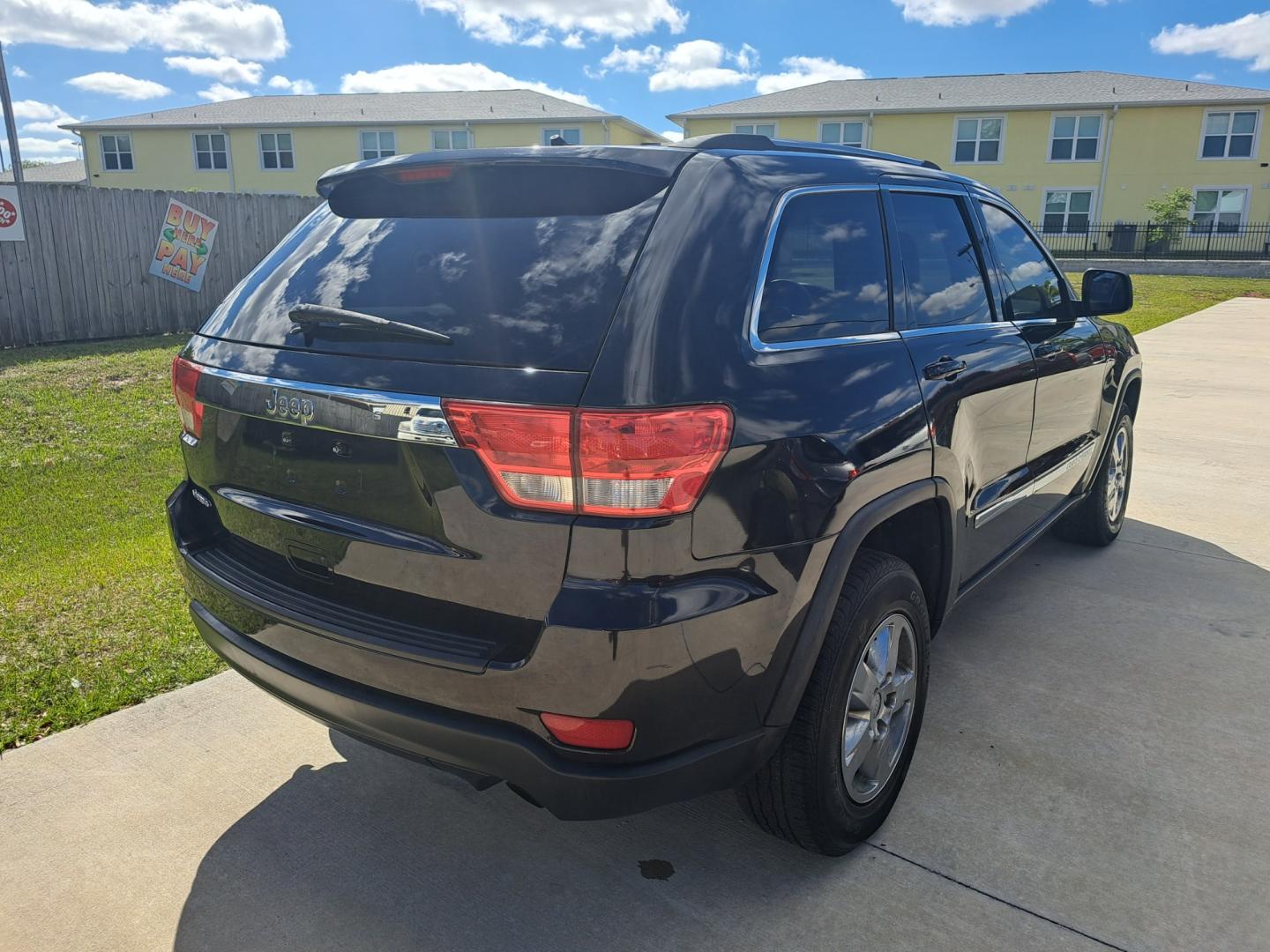 2013 Black Jeep Grand Cherokee Laredo 2WD (1C4RJEAG4DC) with an 3.6L V6 DOHC 24V engine, 5-Speed Automatic transmission, located at 1181 Aurora Rd, Melbourne, FL, 32935, (321) 241-1100, 28.132914, -80.639175 - Photo#2