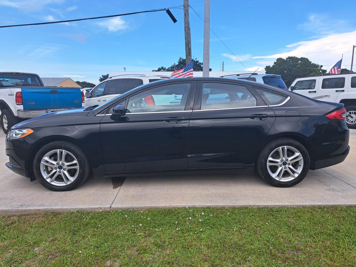 2018 Black Ford Fusion SE (3FA6P0HD5JR) with an 1.5L L4 DOHC 16V engine, 6A transmission, located at 1181 Aurora Rd, Melbourne, FL, 32935, (321) 241-1100, 28.132914, -80.639175 - Photo#0